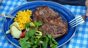 Maine Ribeye steak, corn, potatoes, salad, dinner on canoe trip
